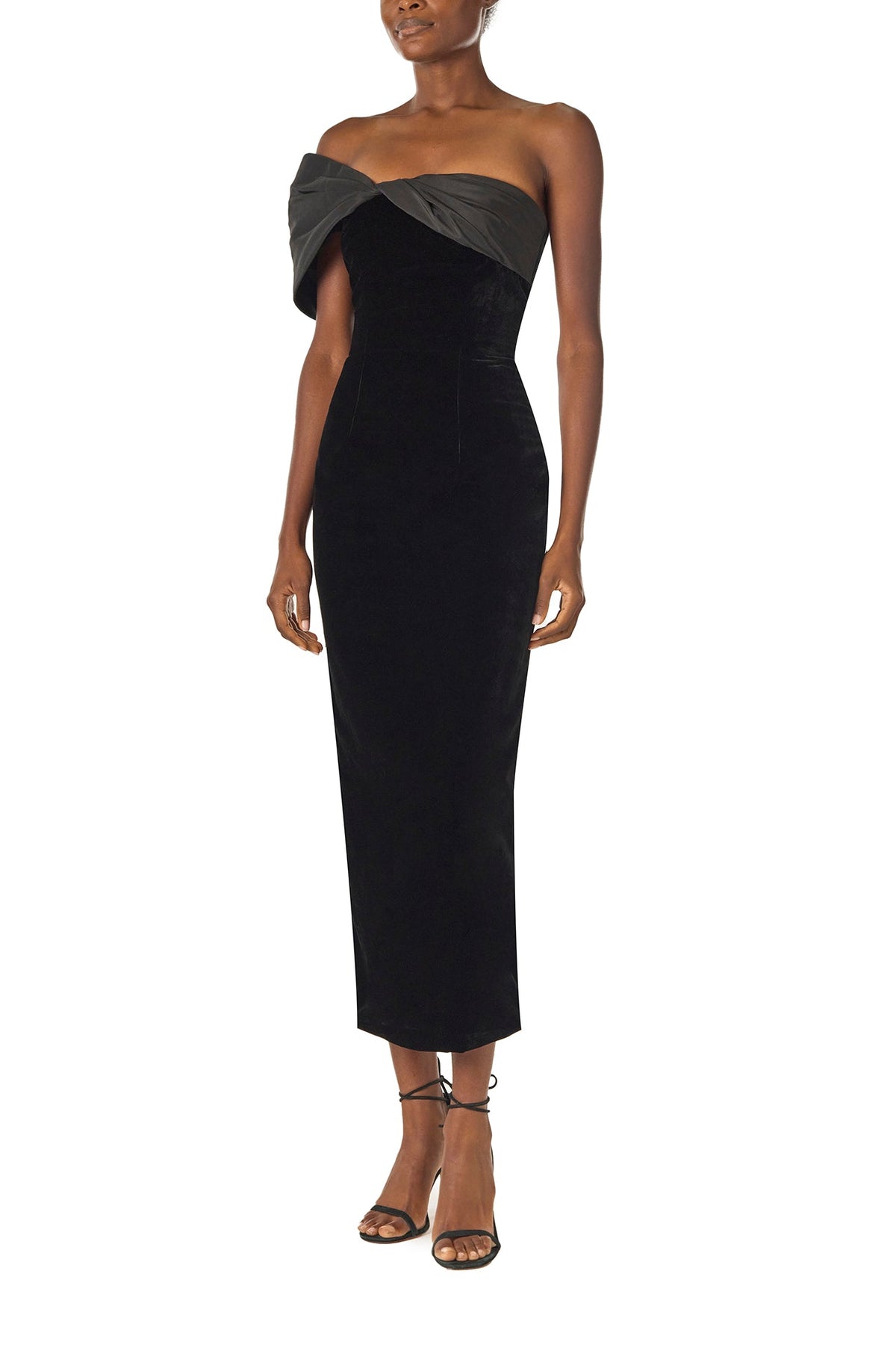 Monique Lhuillier Fall 2024 asymmetric, off the shoulder sheath dress in noir silk faille and velvet with draped twist detail at neckline - left side.