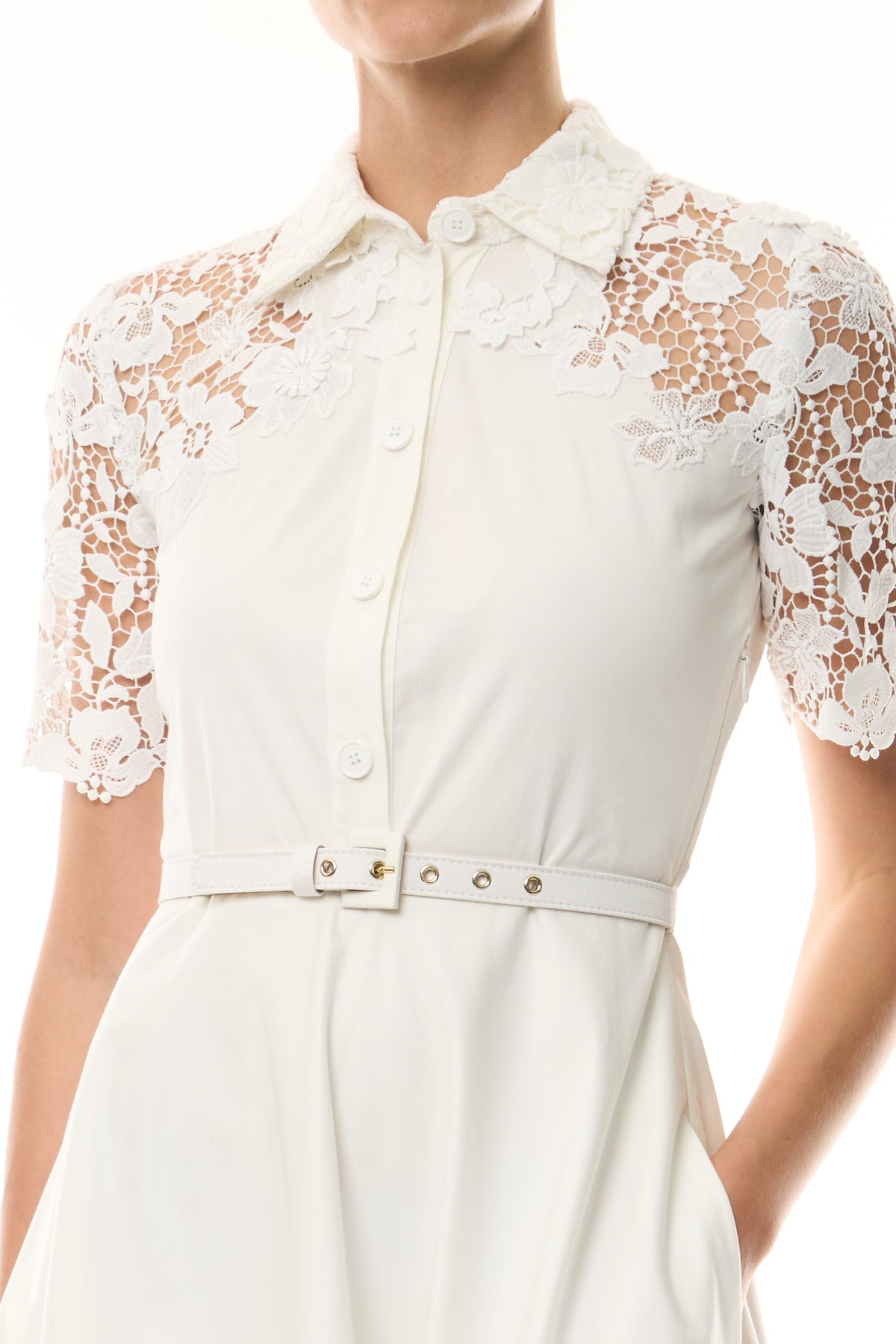 Monique Lhuillier Spring 2025 white cotton poplin dress with lace applique inserts, short sleeves, button down front bodice and belted waist - fabric.
