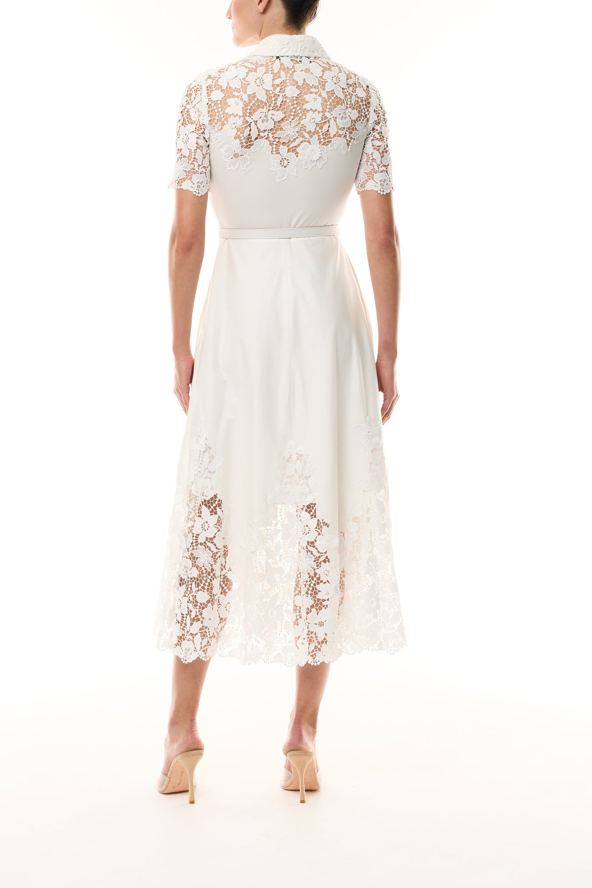 Monique Lhuillier Spring 2025 white cotton poplin dress with lace applique inserts, short sleeves, button down front bodice and belted waist - back.