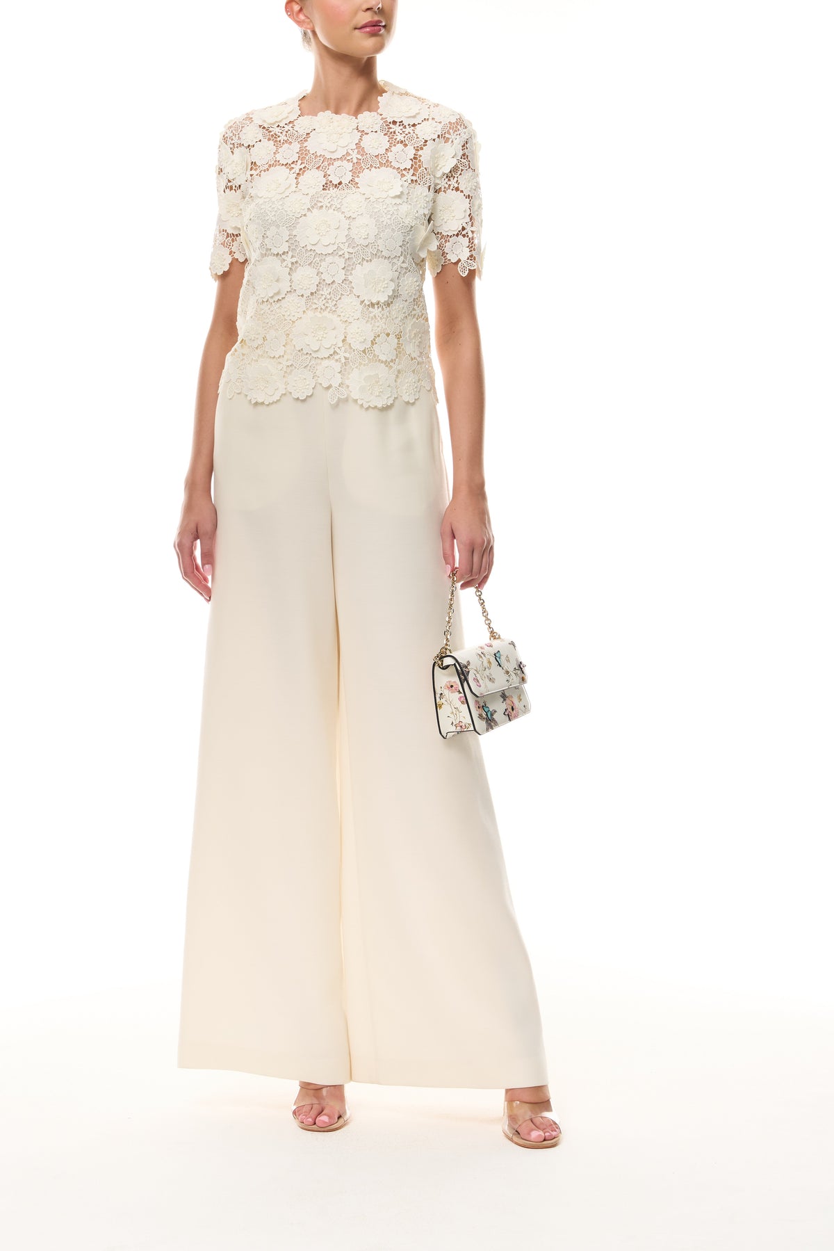 Monique Lhuillier Spring 2026 Ivory three dimensional floral lace Short sleeve blouse
with separate camisole - front with Rhea Mini Tuileries Shoulder Bag